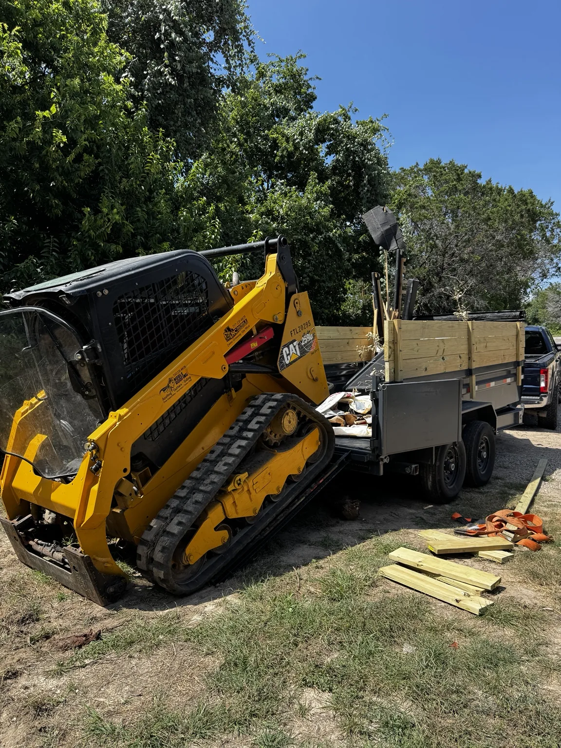 CAT skid steer loading into dump trailer