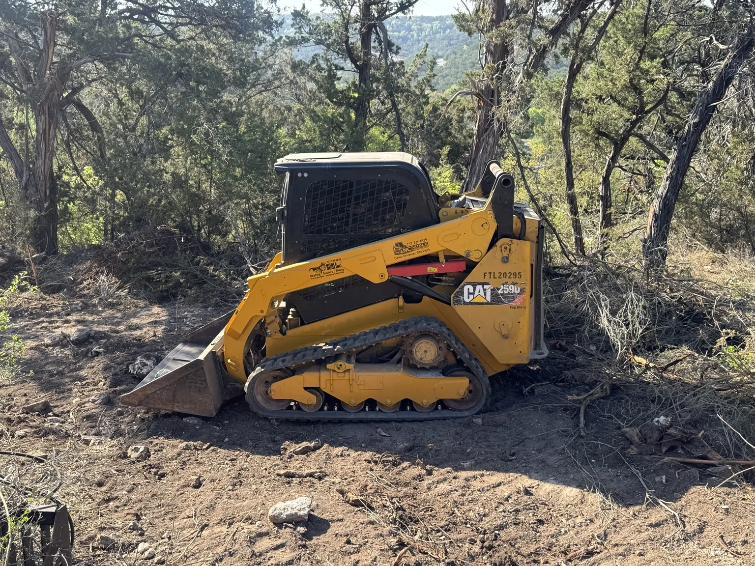 2019 CAT 259D compact track loader on wooded jobsite