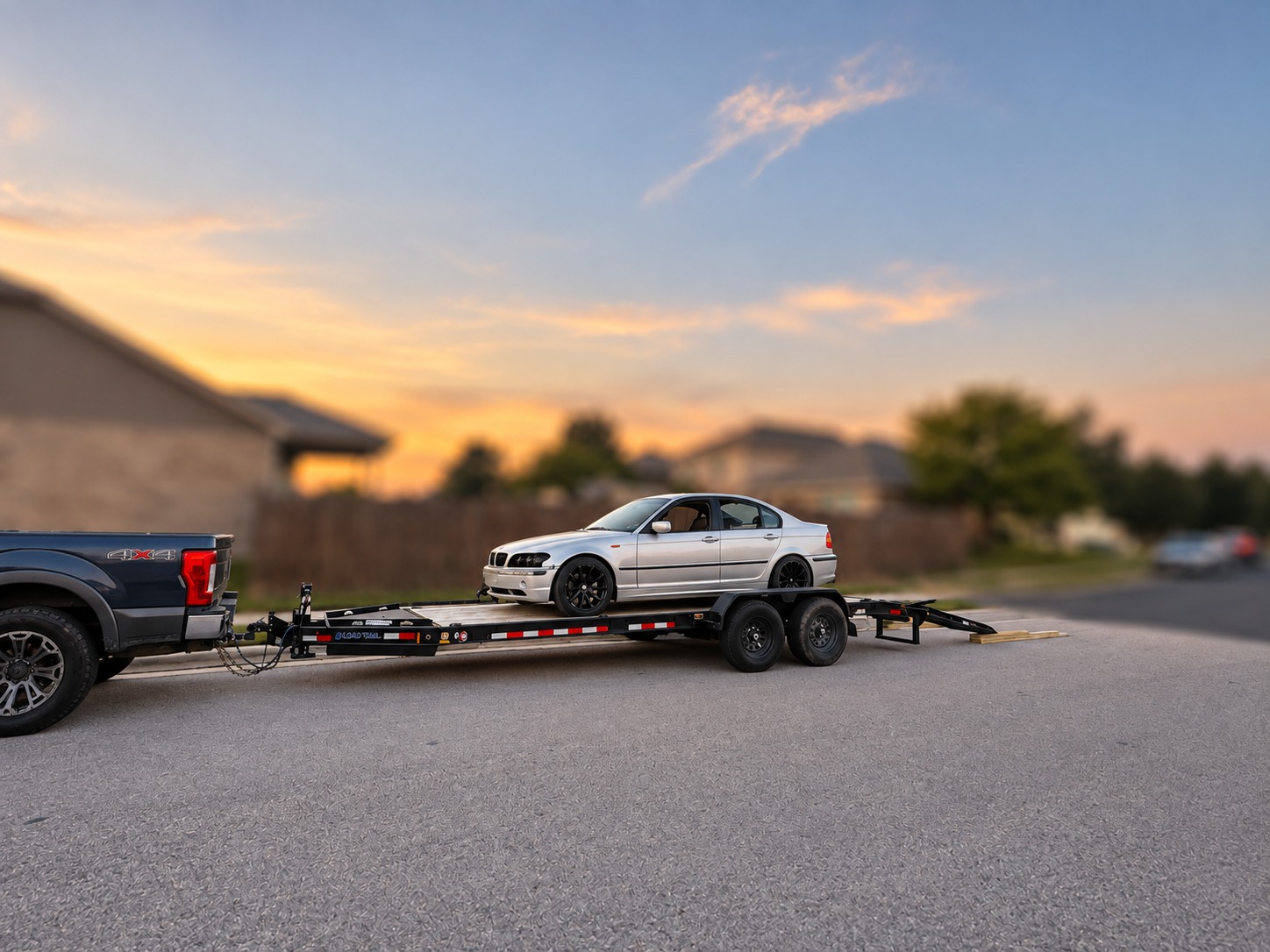 Rear view of car loaded on equipment trailer